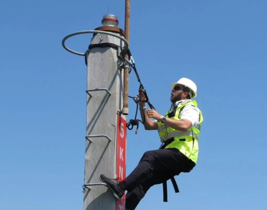 Operative wearing height safety gear securely and safely working on a ladder at height