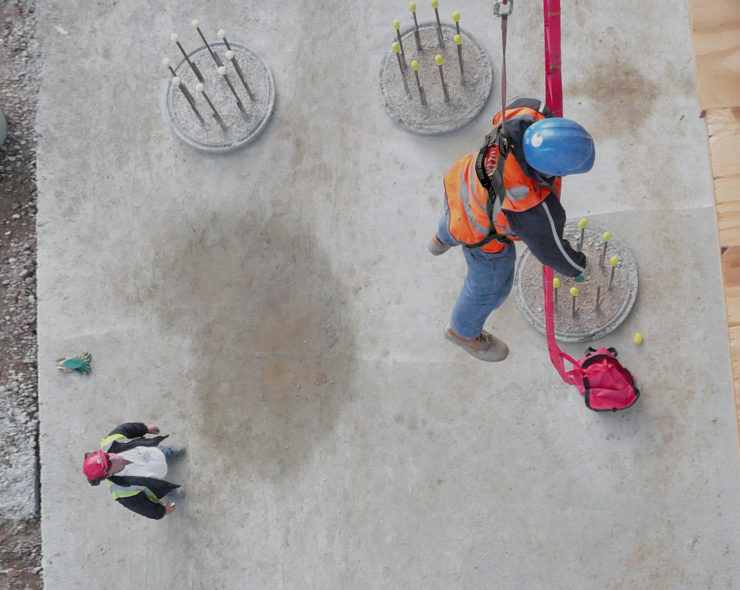 fall casualty example during height safety training . Male in fall position wearing fall restraint equipment