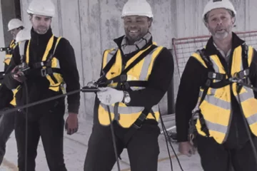 Workers demonstrating how to wear the correct Working at Height Equipment