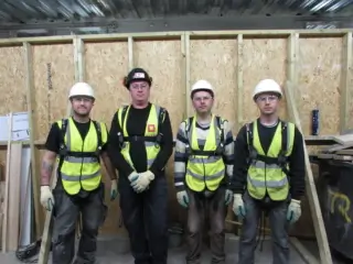 Manager and operatives wearing height safety equipment during working at height training.