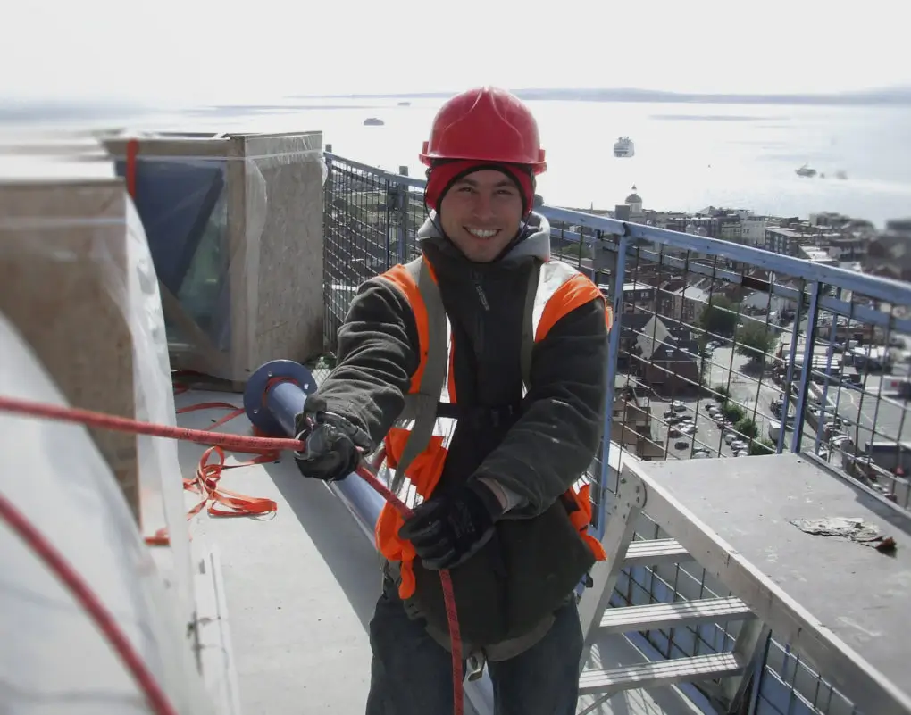 Operative smiling on rooftop during leading edge height safety training course.