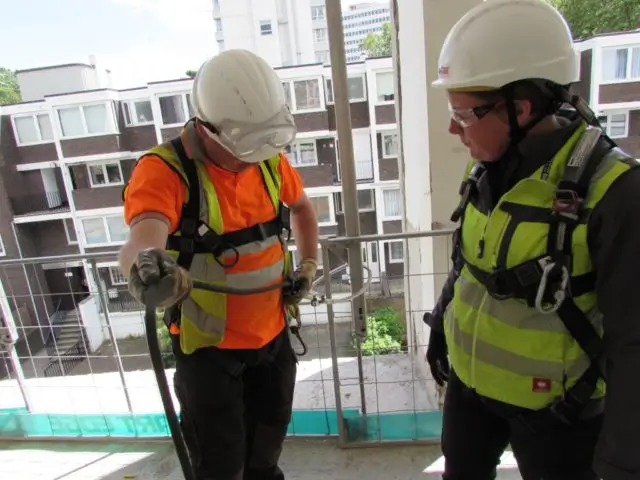 Construction workers wearing full body harness during the working at height basic training course