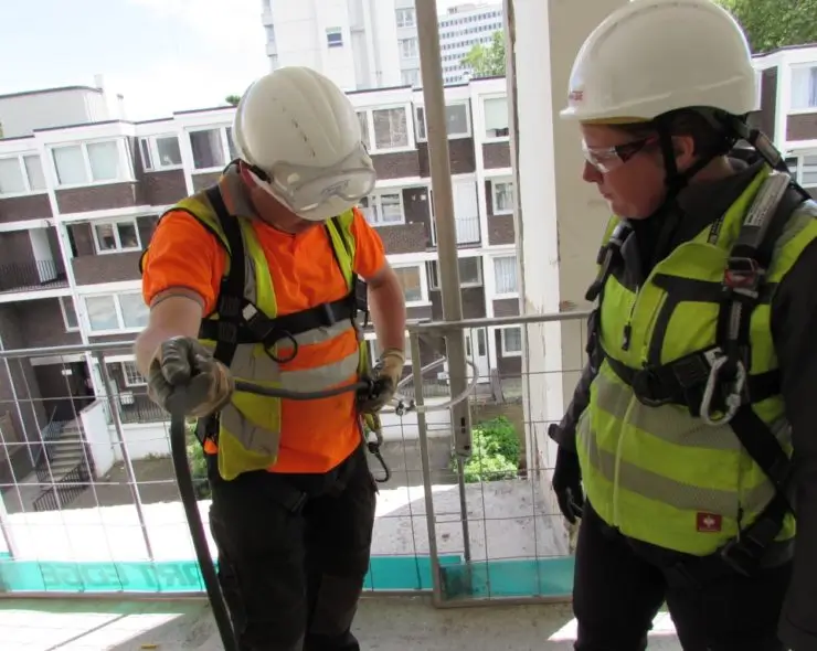 Construction workers wearing full body harness during the working at height basic training course