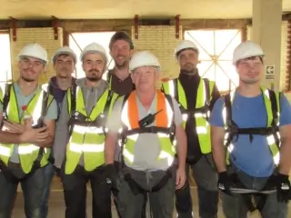 Operatives during best work safety at heights training wearing radio holsters, hard hat, cobra body harness and hi-vis.