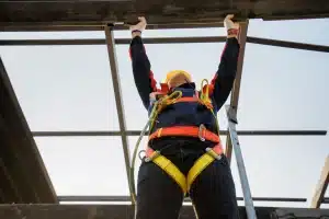 Male wearing height safety harness while working at height