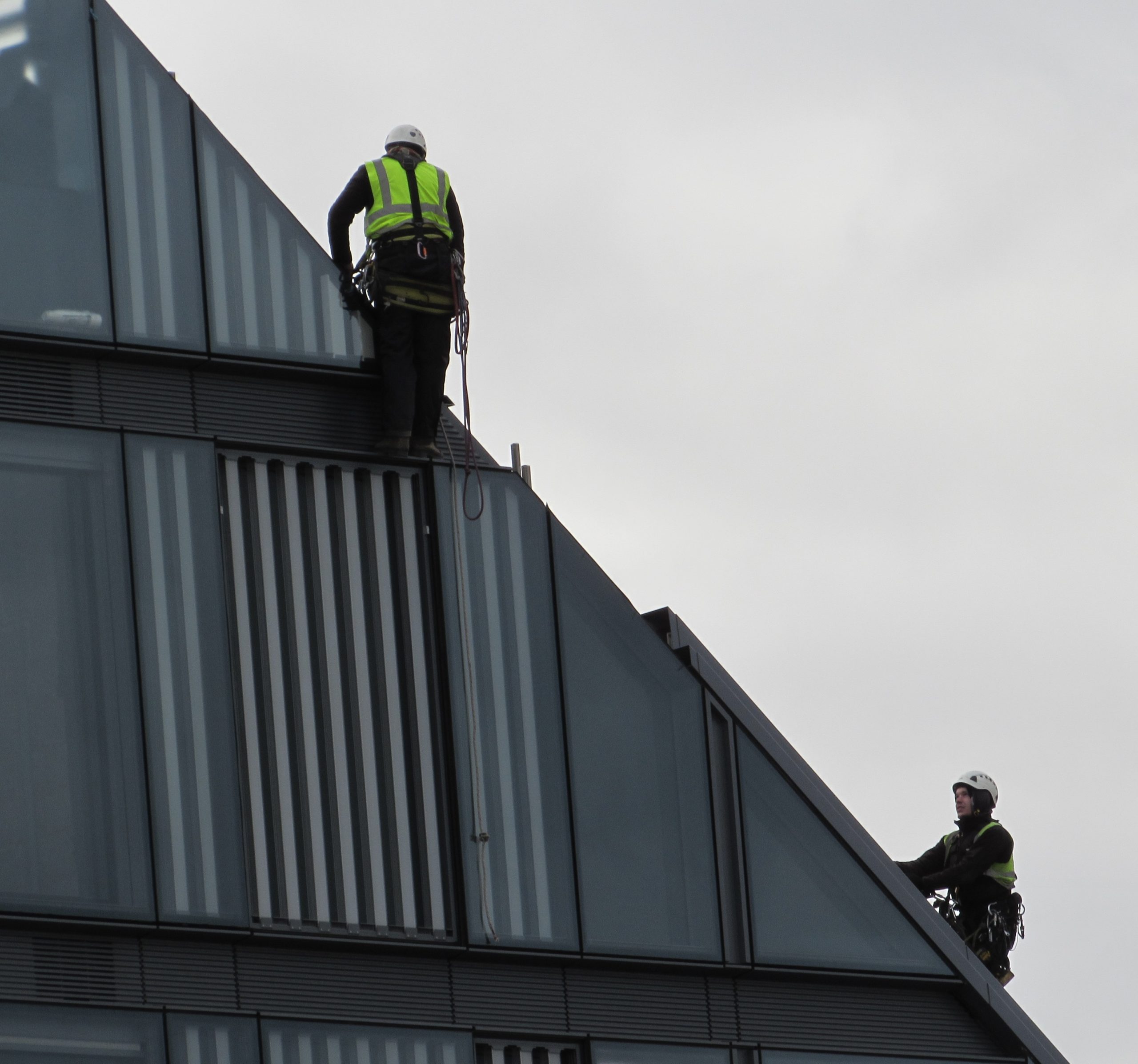 twp men working on the side of a building