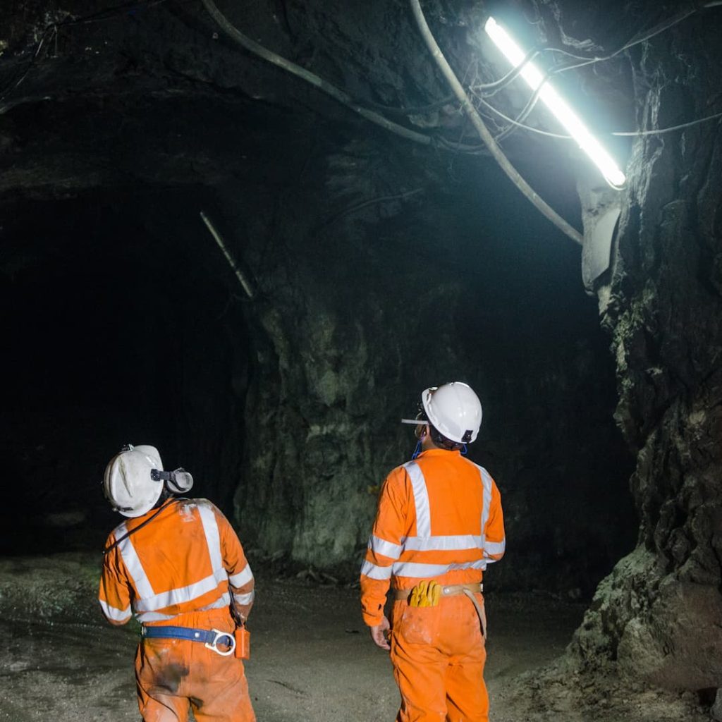 Two males working below ground level