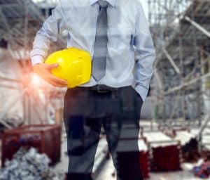 site manager holding a yellow hard hat