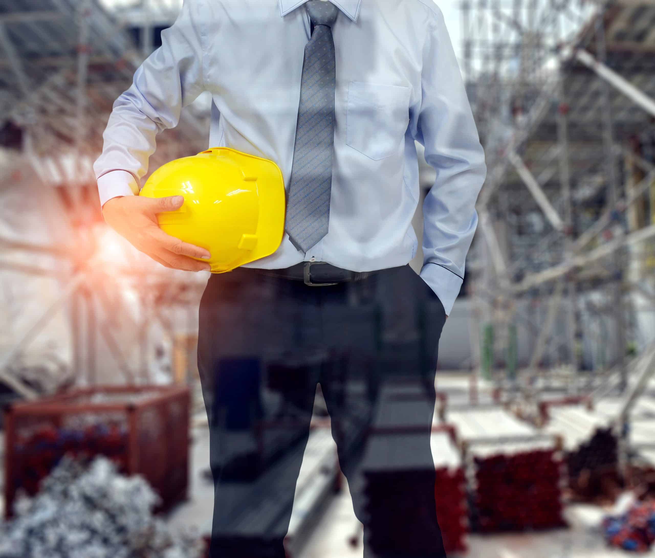 site manager holding a yellow hard hat