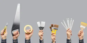hands holding different tools